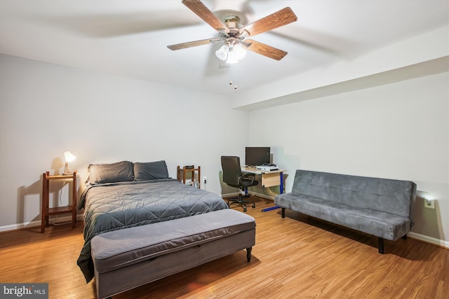 bedroom featuring baseboards, light wood-style flooring, and ceiling fan