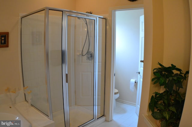 bathroom with toilet and a stall shower