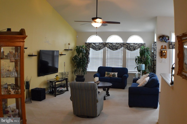 carpeted living area with a ceiling fan