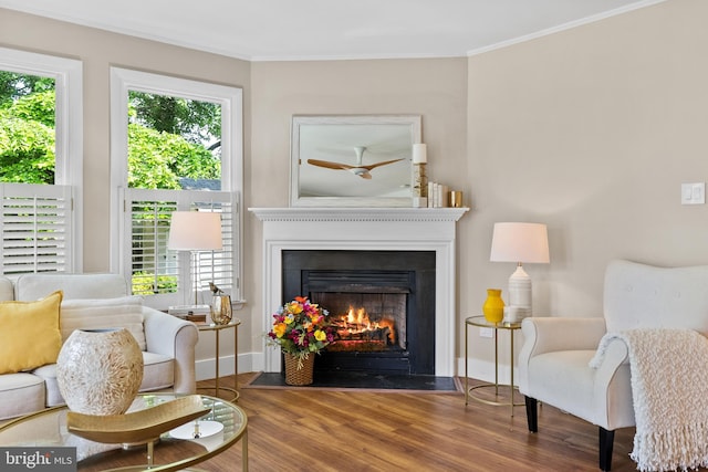 8620 Conover Pl, Alexandria, VA 22308 - living area with a fireplace with flush hearth, wood finished floors, crown molding, baseboards, and a ceiling fan