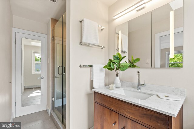 8620 Conover Pl, Alexandria, VA 22308 - full bathroom featuring vanity, plenty of natural light, a stall shower, and tile patterned flooring