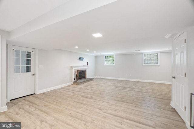 13108 Manor Dr, Mount Airy, MD 21771 - basement featuring light wood-style flooring, a glass covered fireplace, baseboards, and recessed lighting