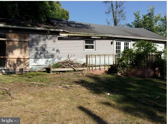 rear view of house with a yard