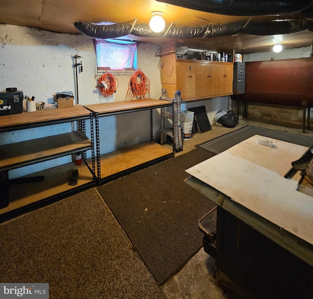 basement with a workshop area and heating fuel