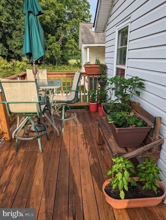 wooden terrace with outdoor dining area