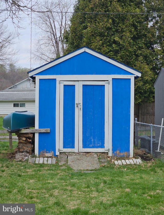 view of shed featuring fence