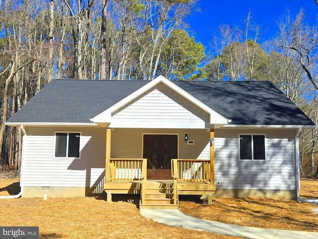 view of front facade with crawl space, covered porch, french doors, and roof with shingles