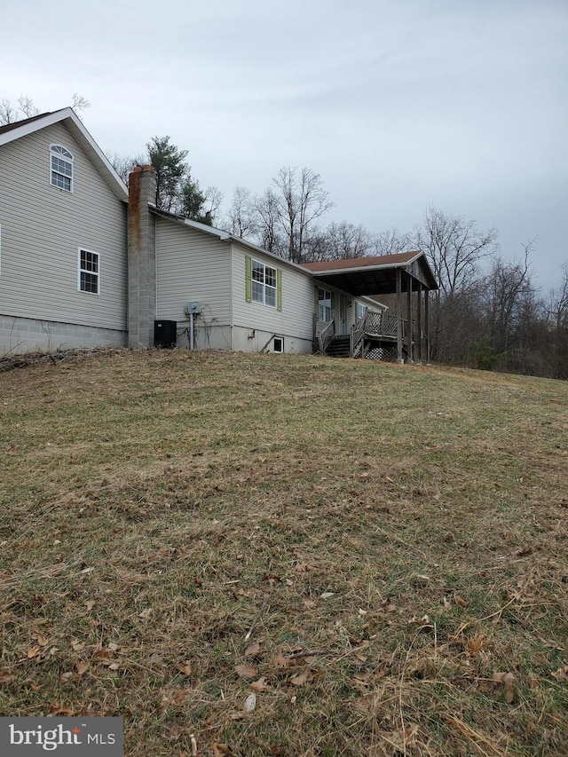 6335 Oxford Rd, Gardners, PA 17324 - rear view of house featuring a carport, a chimney, and a lawn