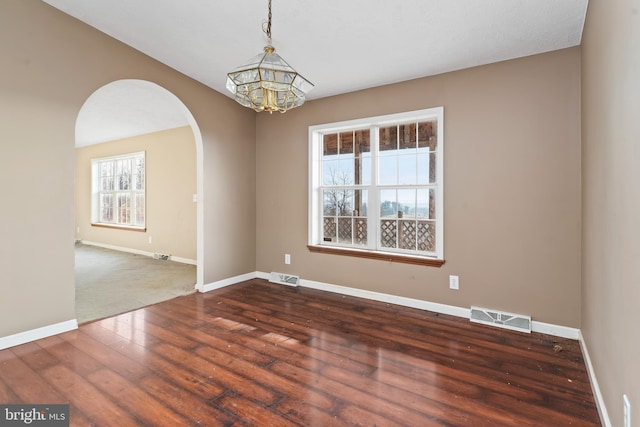 6335 Oxford Rd, Gardners, PA 17324 - unfurnished room featuring a notable chandelier, dark wood-style flooring, baseboards, visible vents, and arched walkways