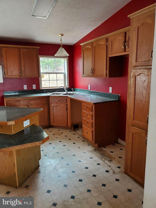 6335 Oxford Rd, Gardners, PA 17324 - kitchen with brown cabinetry, a textured ceiling, a sink, and light floors