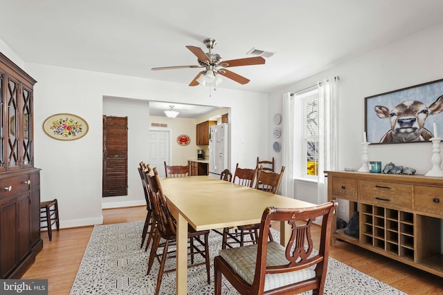 5984 2nd St, Deale, MD 20751 - dining area with baseboards, a ceiling fan, light wood finished floors, and visible vents