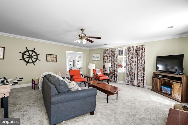 5984 2nd St, Deale, MD 20751 - carpeted living room with arched walkways, baseboards, visible vents, a ceiling fan, and crown molding