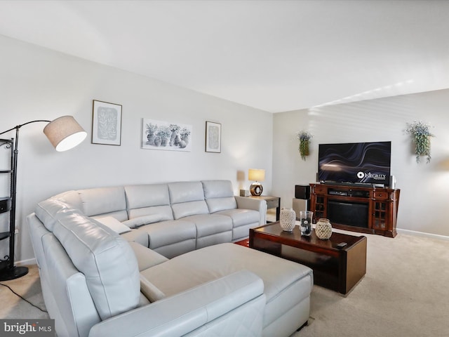 carpeted living room featuring baseboards