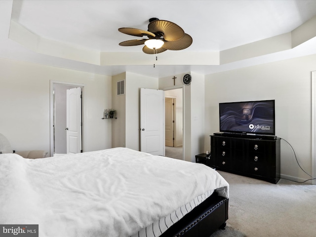 bedroom featuring light carpet, visible vents, and ceiling fan