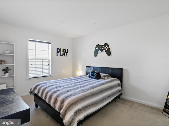carpeted bedroom featuring baseboards