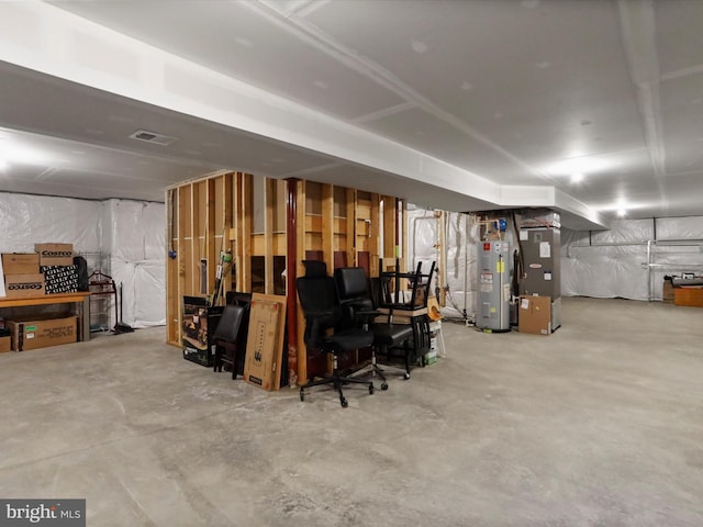 unfinished below grade area with heating unit, electric water heater, and visible vents