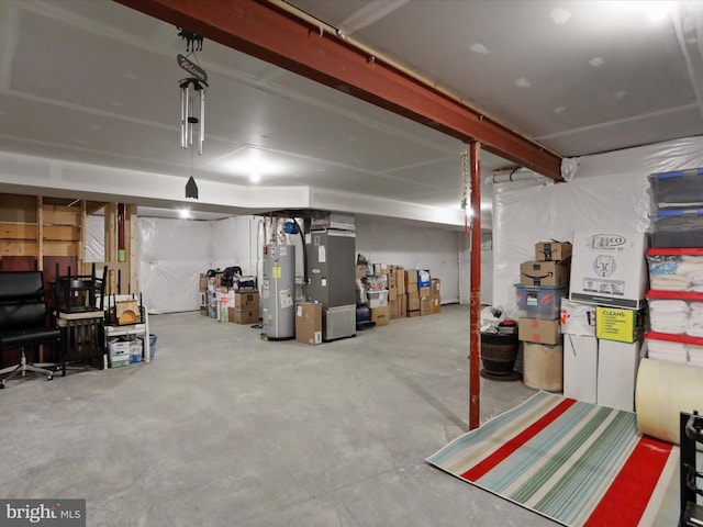 unfinished below grade area featuring heating unit and electric water heater