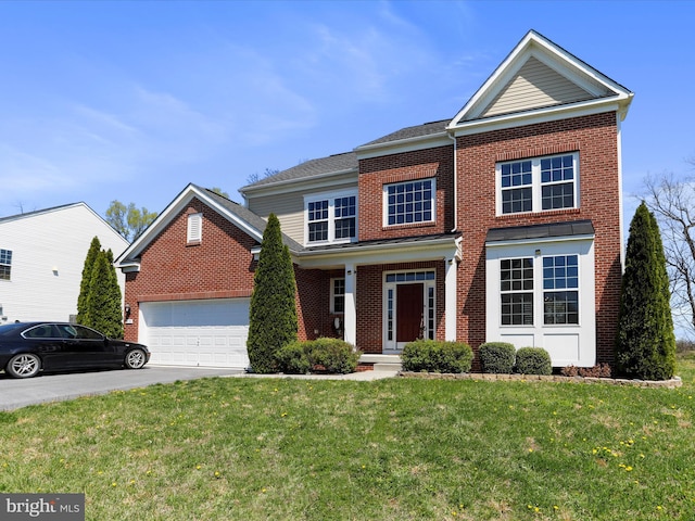 view of front facade featuring brick siding, an attached garage, and a front lawn