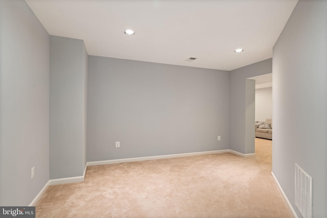 unfurnished room with light colored carpet, visible vents, and recessed lighting