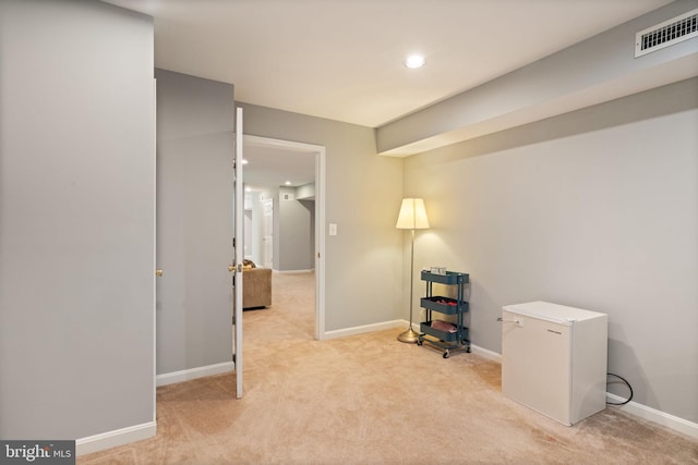 unfurnished office featuring recessed lighting, visible vents, baseboards, and light carpet