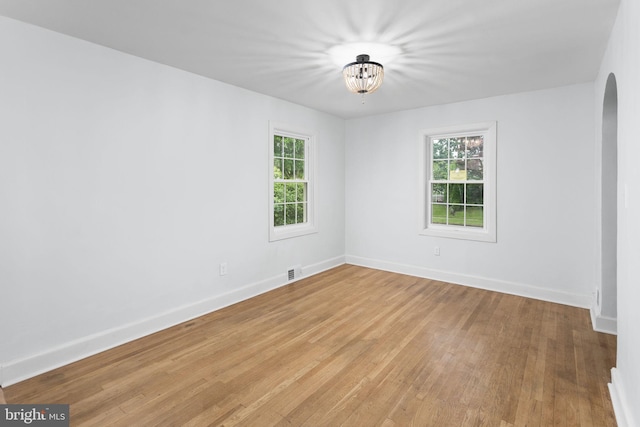 115 Glendale Dr, Ewing, NJ 08618 - unfurnished room featuring light wood-style flooring, plenty of natural light, arched walkways, and baseboards