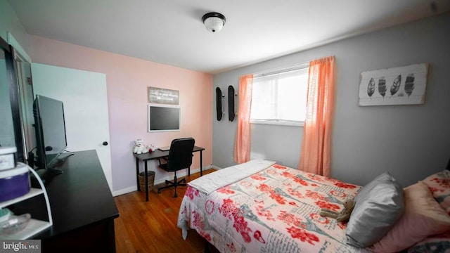 bedroom with dark wood-style flooring