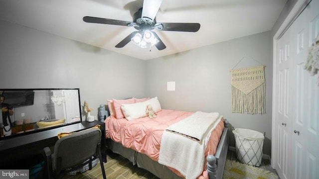 bedroom featuring a closet, a ceiling fan, and wood finished floors
