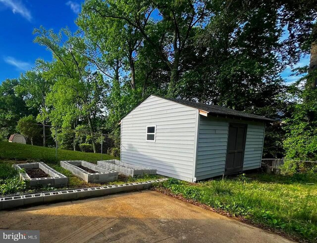 view of shed featuring a garden and fence