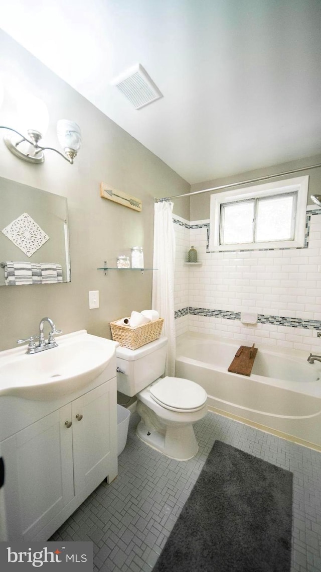 bathroom featuring vanity, toilet, visible vents, and shower / bath combination with curtain