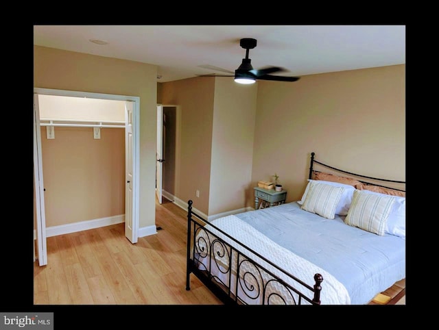 1102 S Carey St, Baltimore, MD 21223 - bedroom with light wood-style floors, a closet, baseboards, and a ceiling fan