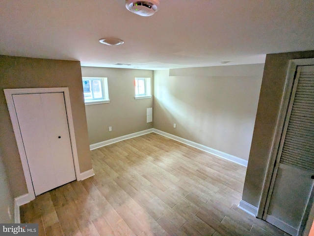 1102 S Carey St, Baltimore, MD 21223 - below grade area featuring light wood-type flooring and baseboards