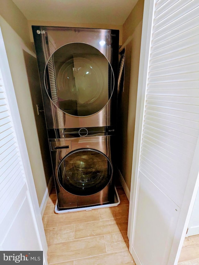 1102 S Carey St, Baltimore, MD 21223 - washroom featuring stacked washer / dryer and wood finished floors