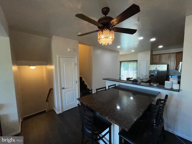 506 Victorianna Dr, Capitol Heights, MD 20743 - kitchen featuring a breakfast bar area, stainless steel appliances, dark wood-type flooring, ceiling fan, and a peninsula