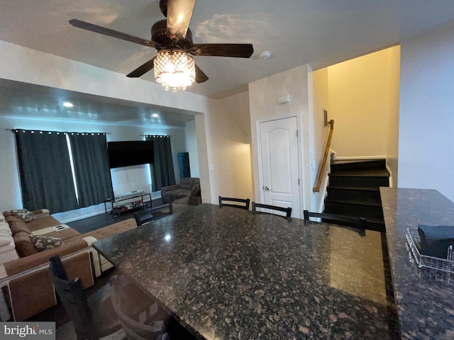 506 Victorianna Dr, Capitol Heights, MD 20743 - kitchen featuring dark stone counters, a ceiling fan, and a breakfast bar