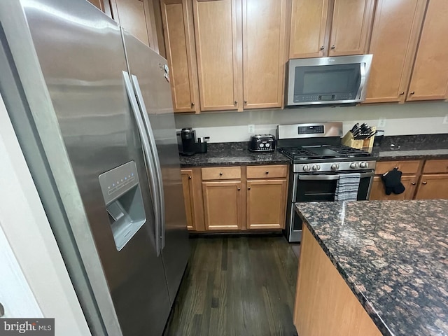 506 Victorianna Dr, Capitol Heights, MD 20743 - kitchen featuring dark wood-style floors, dark stone countertops, and appliances with stainless steel finishes