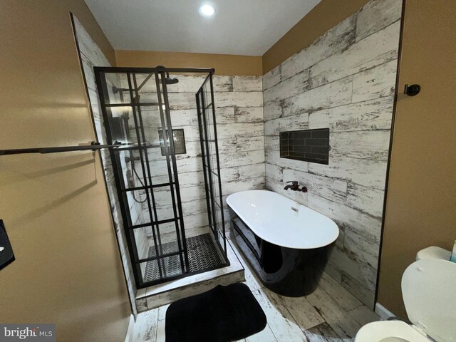506 Victorianna Dr, Capitol Heights, MD 20743 - full bath featuring a soaking tub, toilet, a stall shower, and wood finished floors