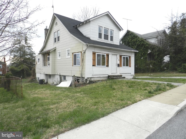view of front of home featuring a chimney, central AC, a front lawn, and entry steps