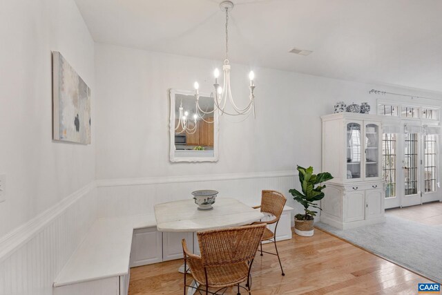 3329 Turnberry Cir, Charlottesville, VA 22911 - dining area featuring visible vents, wood finished floors, a notable chandelier, and wainscoting