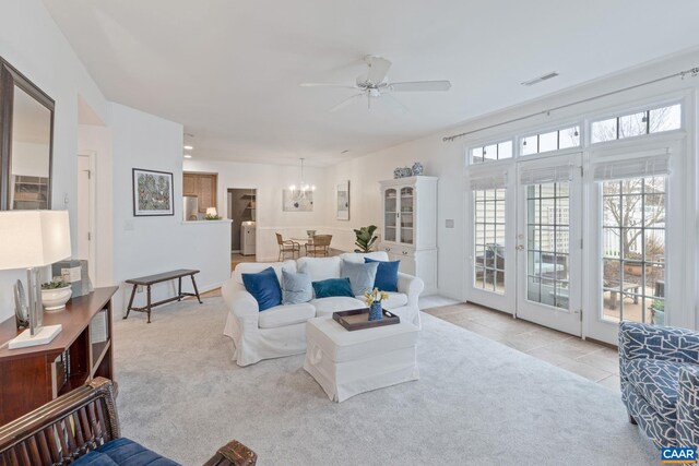 3329 Turnberry Cir, Charlottesville, VA 22911 - living area with visible vents, washer / clothes dryer, carpet floors, ceiling fan with notable chandelier, and tile patterned flooring