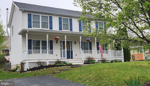 colonial house with a porch and a front lawn