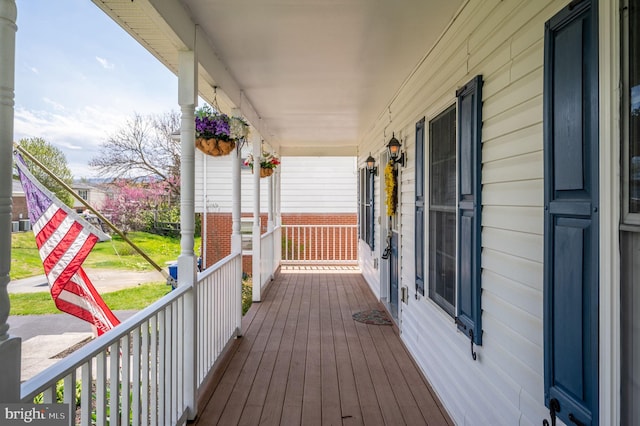 wooden terrace featuring covered porch