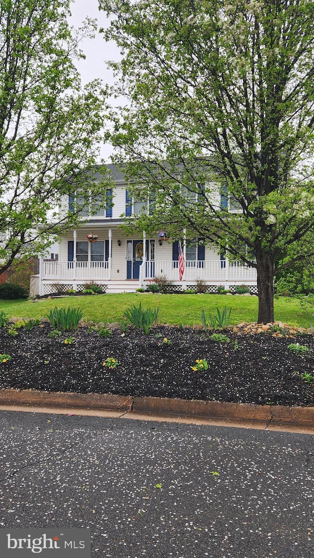 view of front of house with covered porch and a front yard