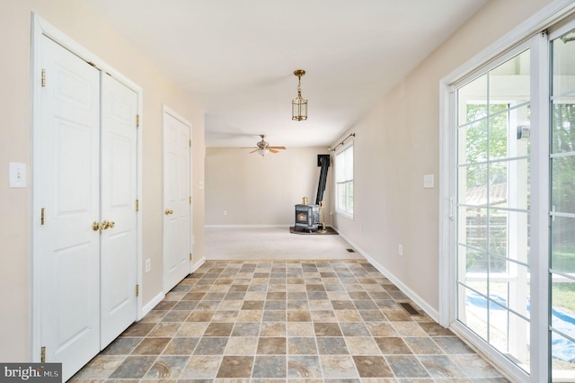 interior space with visible vents, baseboards, carpet, and stone finish flooring