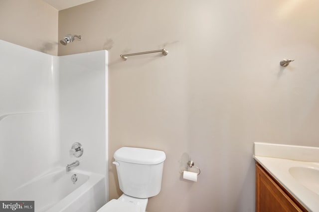 bathroom featuring vanity, shower / bathing tub combination, and toilet