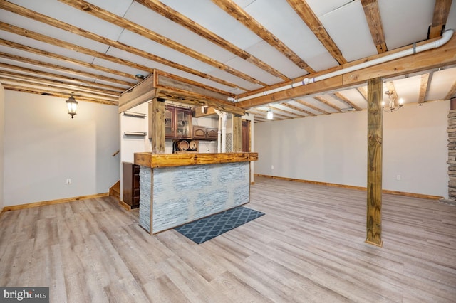 kitchen featuring open shelves, light wood-style floors, and baseboards