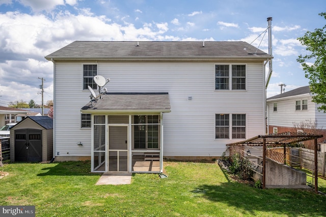 back of house with a yard, a storage shed, an outdoor structure, and a sunroom