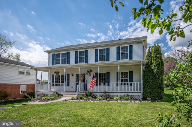 colonial-style house with a front yard and a porch