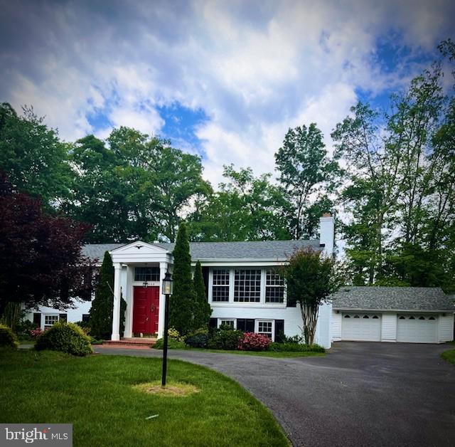 4508 Guinea Rd, Fairfax, VA 22032 - view of front of house with a garage, a front yard, and a chimney