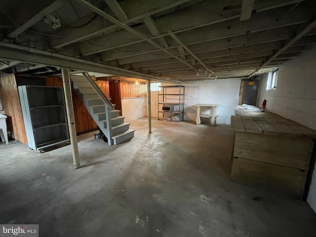 below grade area with stairway and concrete block wall