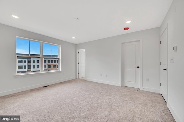 unfurnished bedroom featuring baseboards, visible vents, and carpet